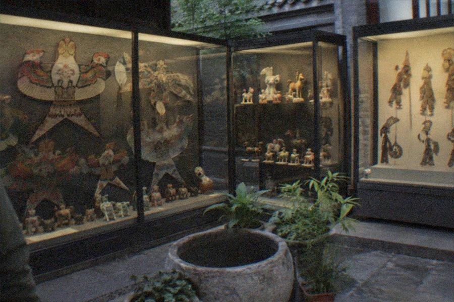Gate of the Beijing Folklore Museum at Dongyue Temple on Chaoyangmenwai Street with traffic passing outside