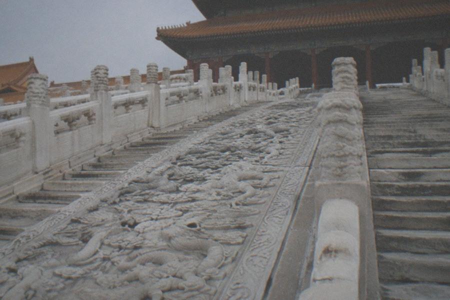 Golden roofed palace halls and red walls of the Forbidden City under a wide morning sky