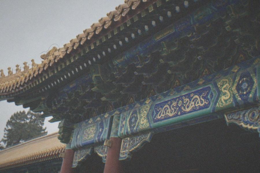 Red-walled Tibetan Buddhist temple halls with incense smoke rising above tiled roofs