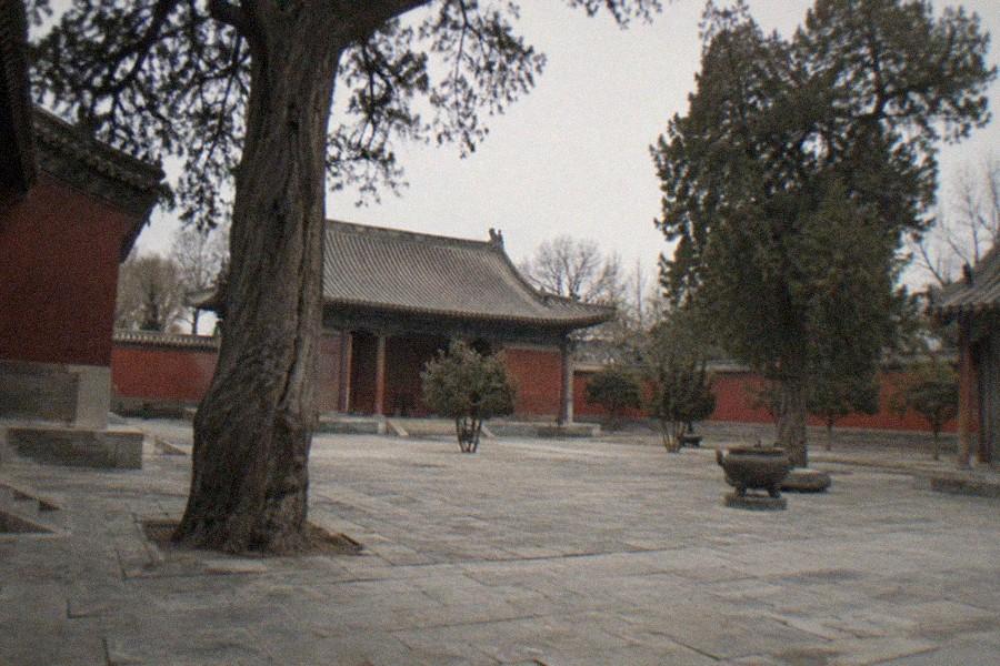 Stone altar platform and timber halls in a quiet walled courtyard in Beijing