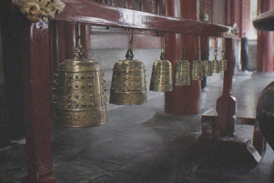 Rows of historic bronze bells displayed in a temple hall at the Great Bell Temple Ancient Bell Museum