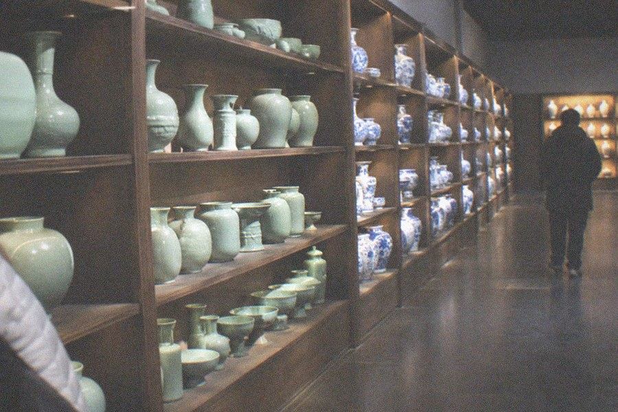 A gallery in the Guanfu Museum with classical Chinese hardwood furniture arranged as a furnished room