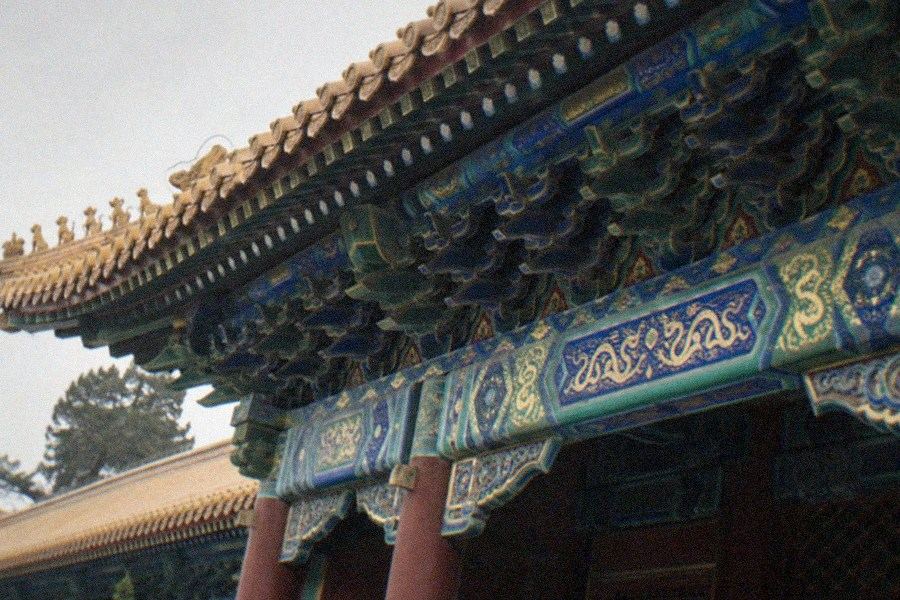Interior of the Hall of Infinite Compassion at the Lama Temple (Yonghegong) with its tall sandalwood Buddha statue and hanging silk canopies